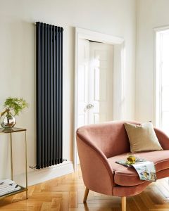 1800 x 425mm 2 column vertical radiator in matt black - styled living room with velvet armchair - Kartell Laser Klassic