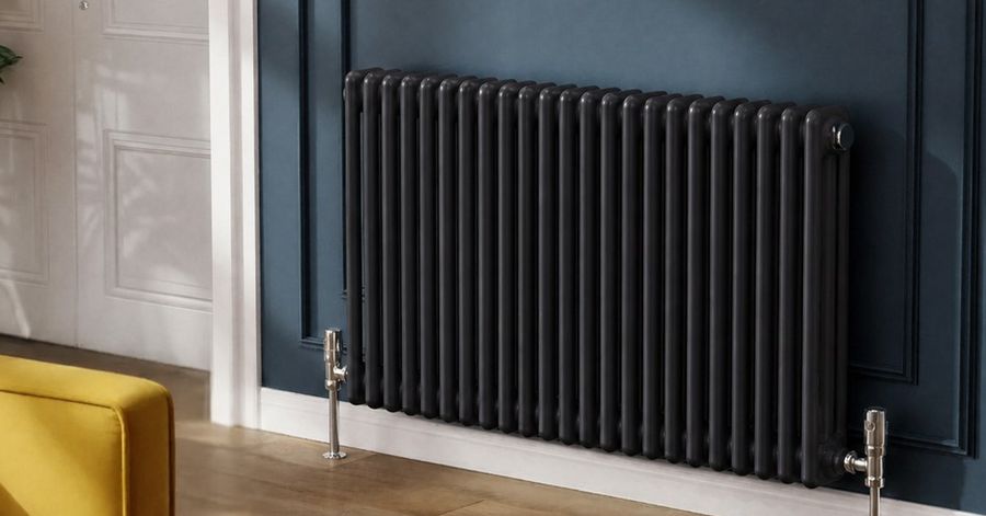 Black DUSC column radiator on a navy wall
